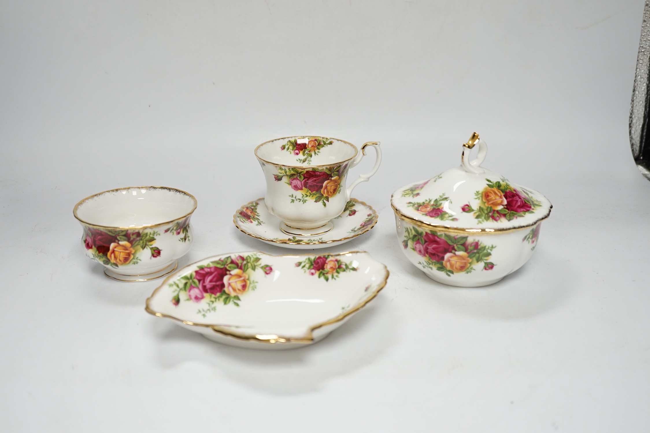 A quantity of Royal Albert old country roses pattern teawares including teapot, various cups and saucers, side plates, cake stand, coffee, pot, quartz, clock, sugar bowl, trays, etc.